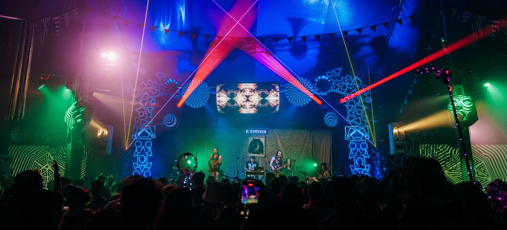 OTTERtorium, interactive stage flowing live with black and white striped decor, visuals and band